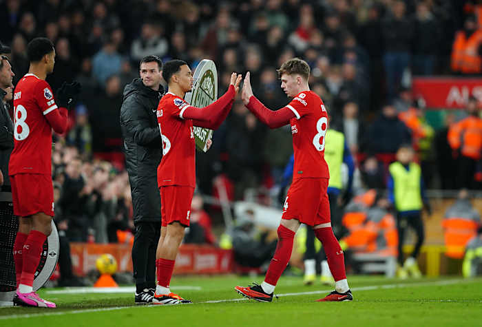 Conor Bradley pictured (right) being substituted off for Liverpool teammate Trent Alexander-Arnold during a 4-1 win over Chelsea in January 2024